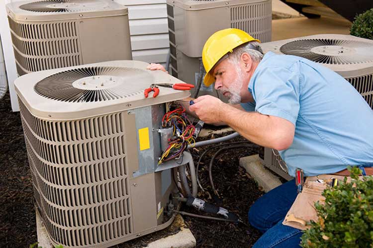 HVAC technician fixing AC unit in Dunedin